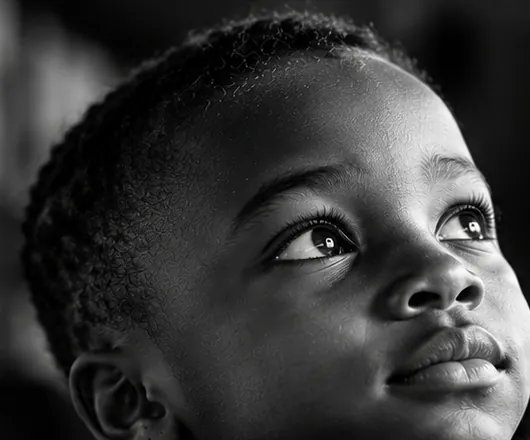 Close-up of a young boy looking upward